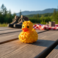 Mac and Cheese Duck 3D printed figure on rustic outdoor background